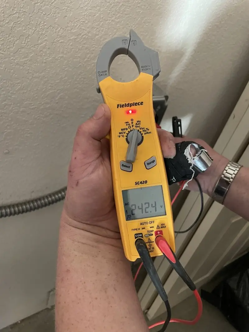Voltage testing with clamp meter during Ceiling Fan Installation in Milton